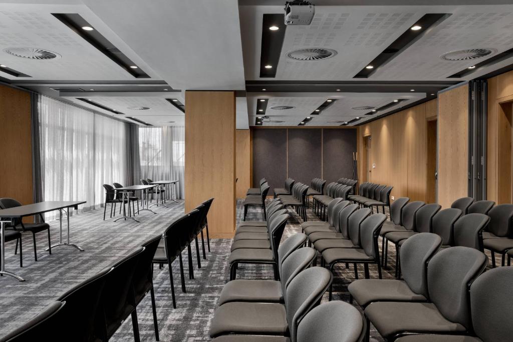a room with rows of chairs and tables at AC Hotel by Marriott Cape Town Waterfront in Cape Town
