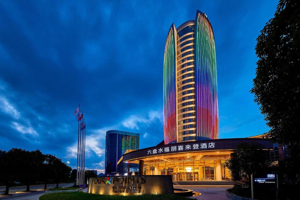 a building with colorful lights on the side of it at Four Points by Sheraton Liupanshui in Shuicheng
