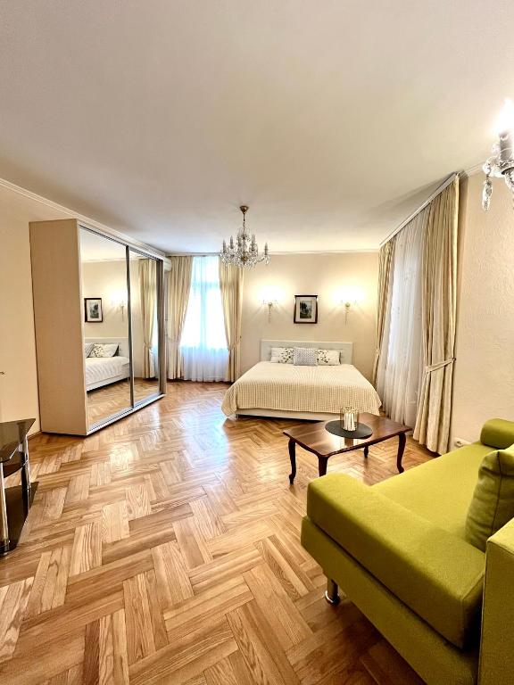 a living room with a bed and a couch at Апартаменты в самом центре столицы. in Kyiv