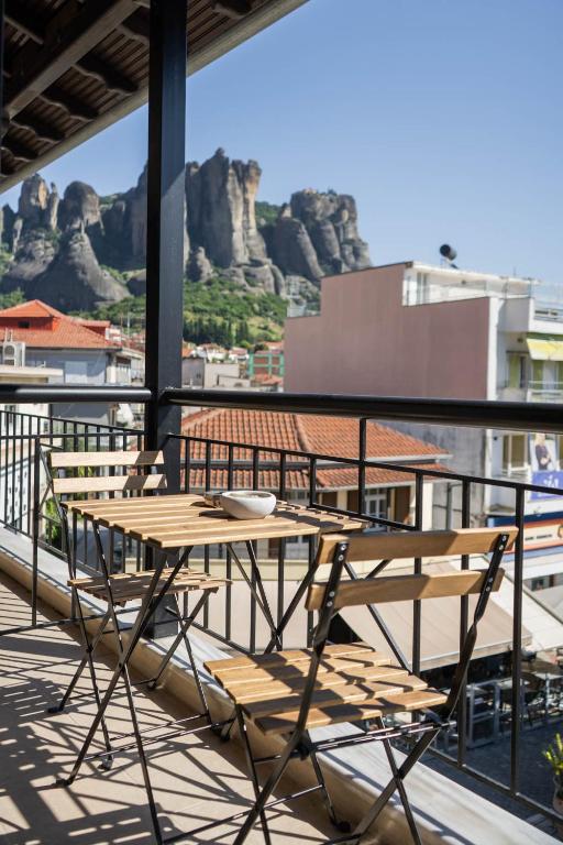 a table and chairs on a balcony with a view at ALBA SUITE APARTMENT in Kalabaka