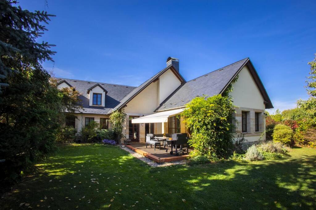 a large white house with a patio and a yard at 7 Bedroom Secluded Villa close to Prague in Ricany