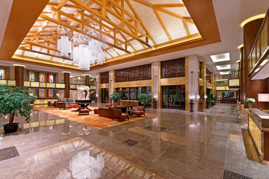 a lobby of a hotel with a large ceiling at Sheraton Grand Hangzhou Wetland Park Resort in Hangzhou