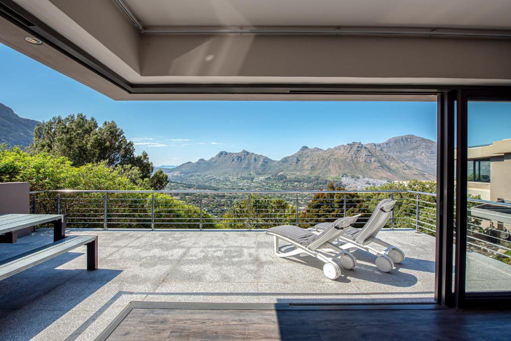 a house with a balcony with a view of mountains at Endless Views in Cape Town