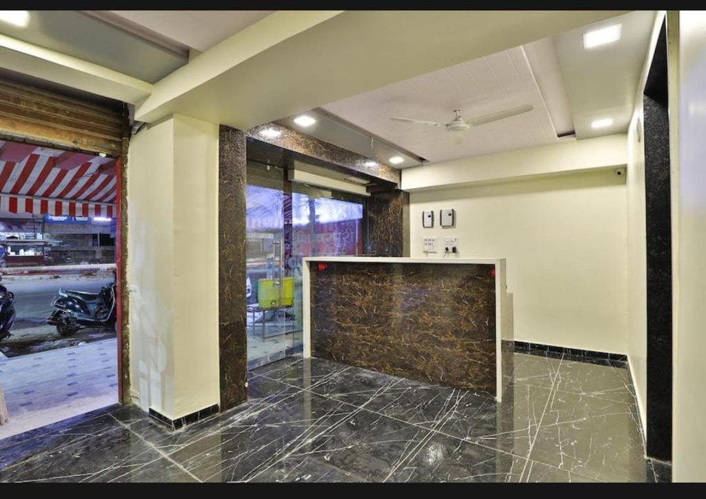 a room with a lobby with a stone wall at HOTEL SUNWAY in Ahmedabad