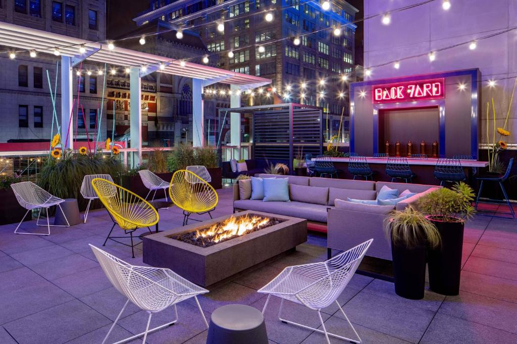 a patio with a couch and chairs and a fire pit at Aloft Philadelphia Downtown in Philadelphia