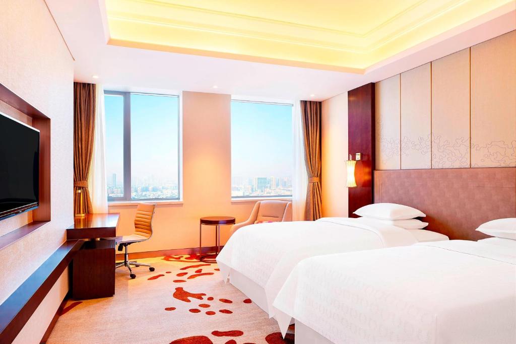 Postel nebo postele na pokoji v ubytování Sheraton Harbin Xiangfang Hotel