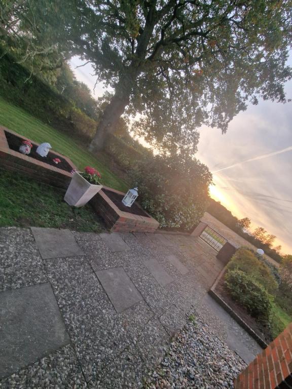 a person sitting on a bench near the water at Fewo "Lütt Stuv" in Fockbek