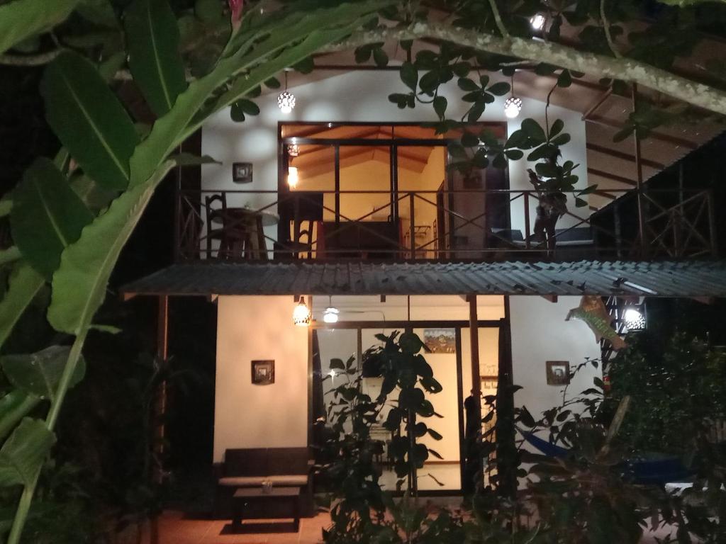 a view of a house from the garden at night at Casa Martina in Cahuita