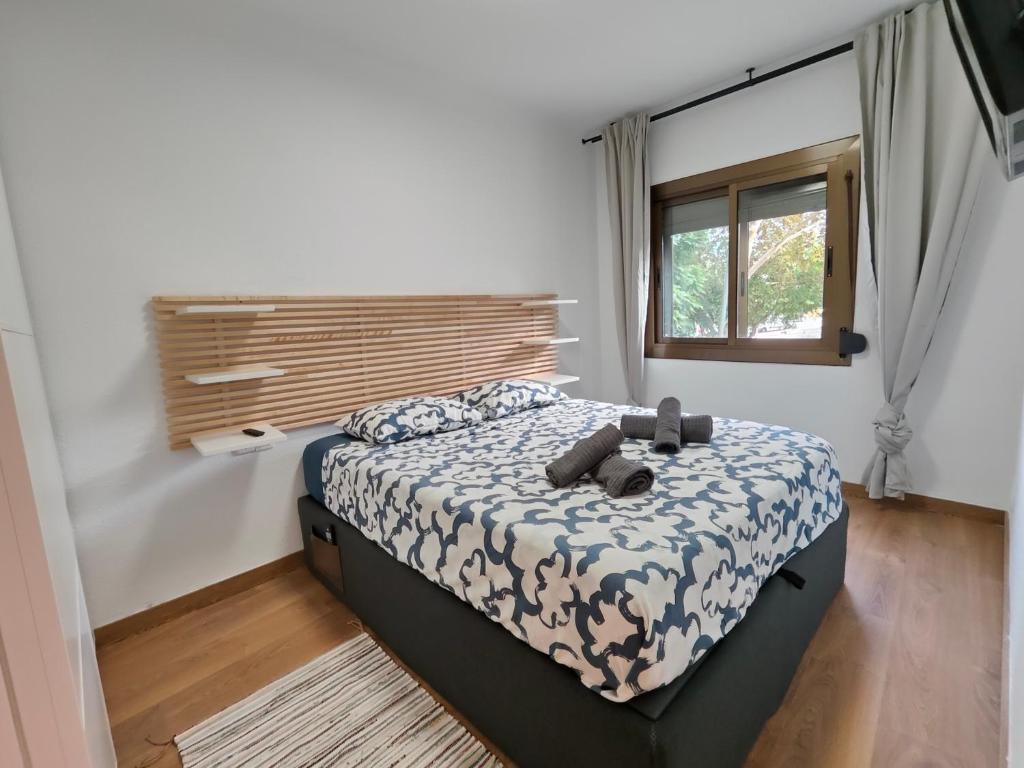 a bedroom with a bed and a window at Family apartment Besos 2 in Barcelona