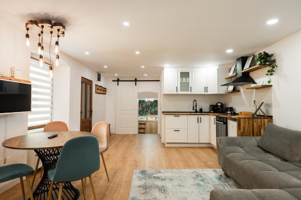 a kitchen and living room with a couch and a table at Rope Street eState Picturesque in Braşov