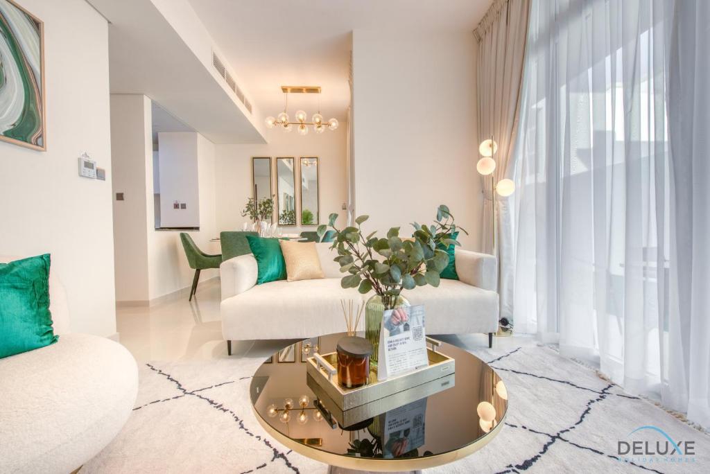 a living room with a couch and a table at Restful 3BR Townhouse at DAMAC Hills 2 Dubailand by Deluxe Holiday Homes in Dubai