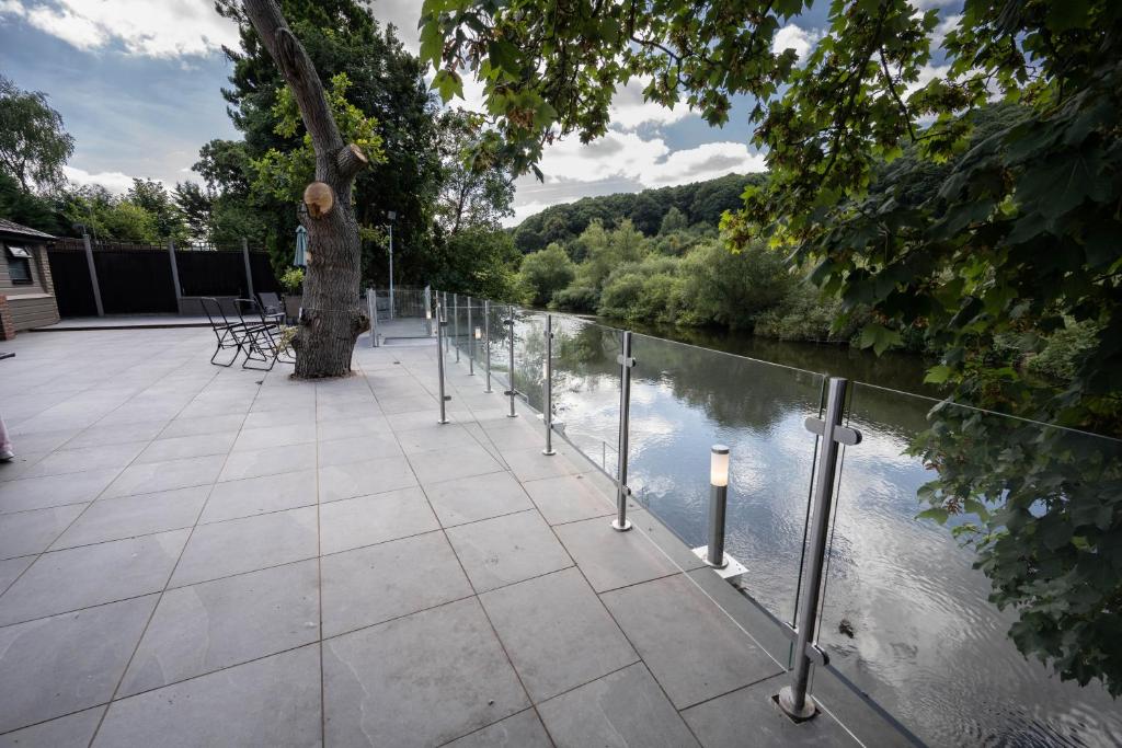 a patio next to a body of water at The New Larches in Bewdley