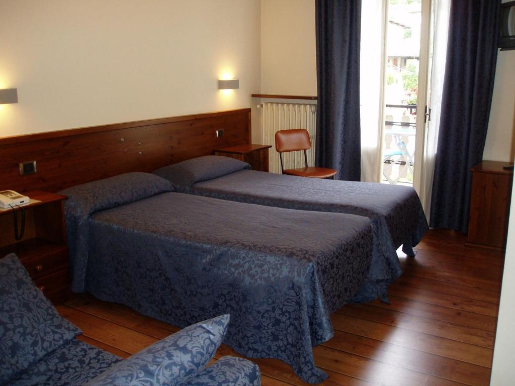 Postel nebo postele na pokoji v ubytování Albergo Delle Alpi