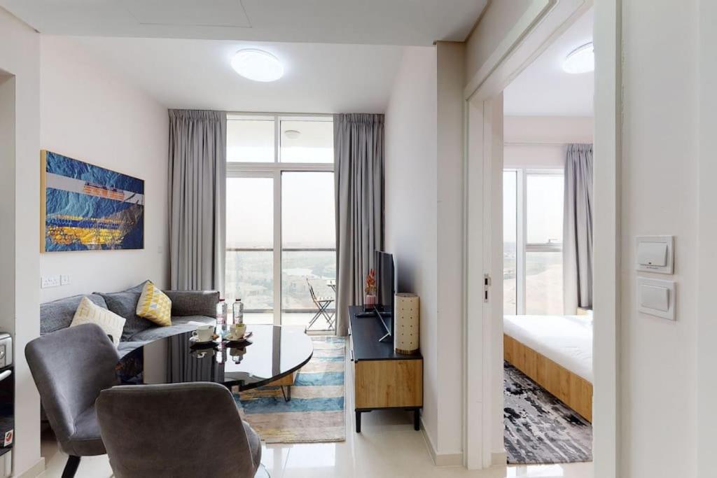 a living room with a bed and a table and chairs at Key View - Golf Vita in Dubai Marina