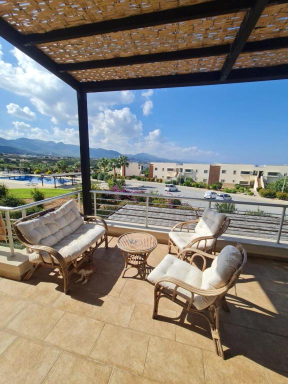 a patio with chairs and a table and a view at Penthouse with rooftop terrace in Akanthou