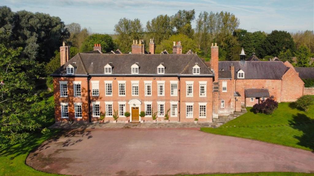 an aerial view of a large brick house with a driveway at Blyth Hall in Coleshill