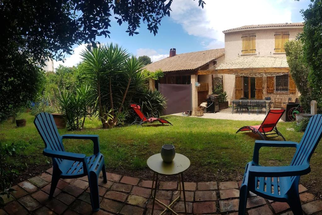 a group of chairs and a table in a yard at Petit Paradis au calme en plein Marseille in Marseille