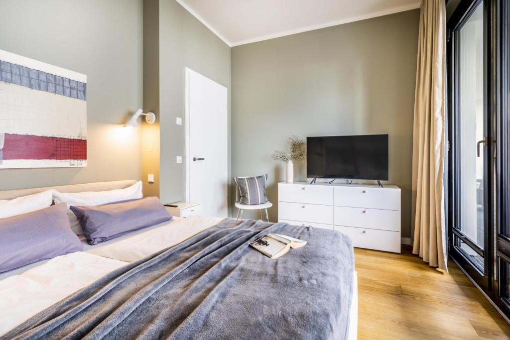 a bedroom with a large bed with a tv on it at Sparkassengebäude Wohnung 1 in Borkum