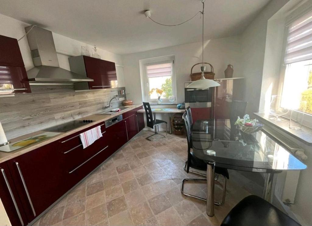 a kitchen with a glass table and a counter top at Ferienwohnung in Ehrenfriedersdorf in Ehrenfriedersdorf