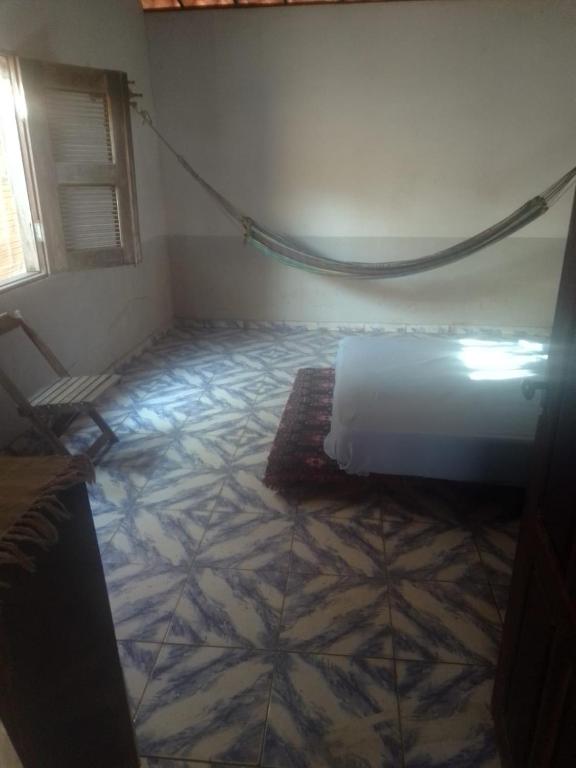 a bedroom with a bed and a tiled floor at Sol do Paraiso in Jijoca de Jericoacoara