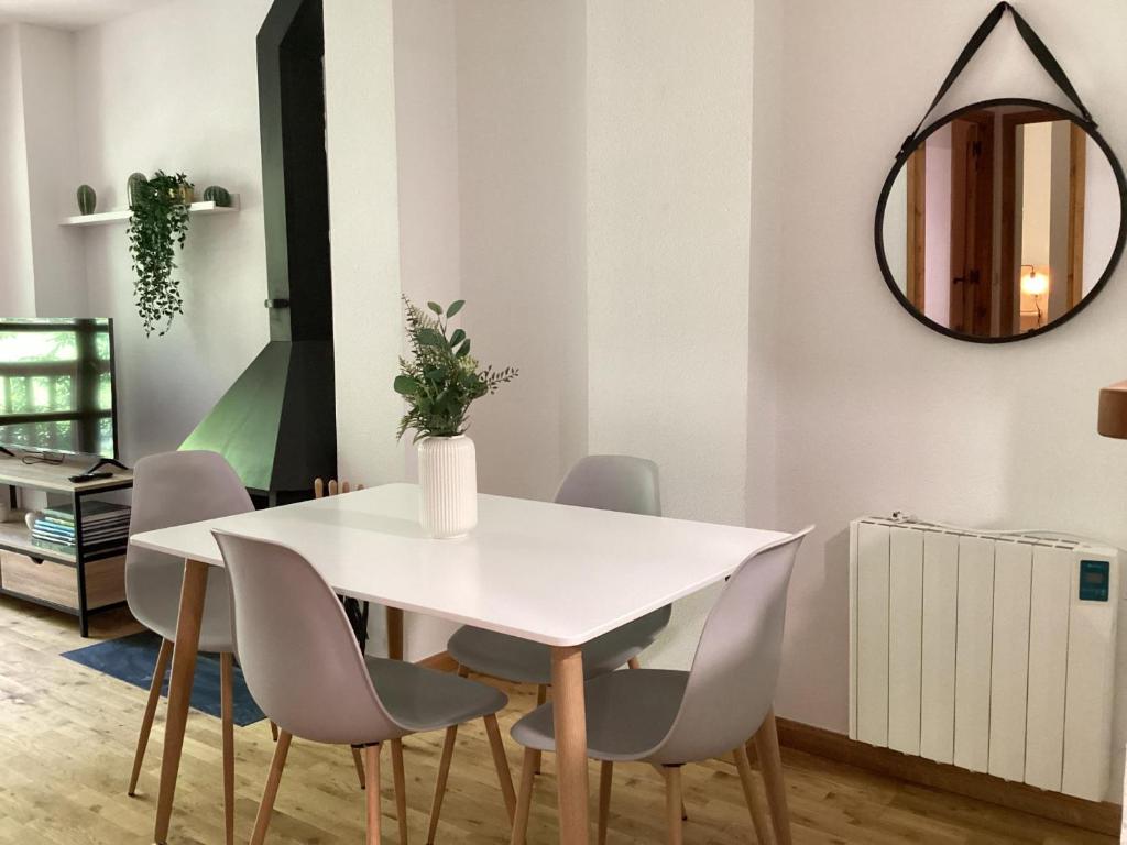 a dining room with a white table and chairs at P06 Dellui By Immovall in Pla de l'Ermita