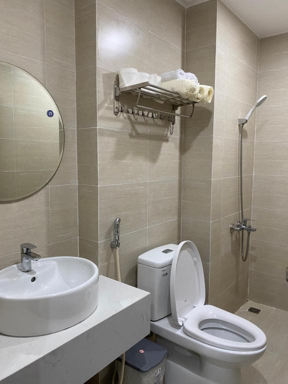 a bathroom with a sink and a toilet and a mirror at Mô Tê Huế Homestay in Hue