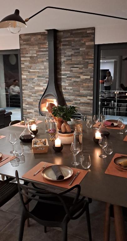 a table with candles and wine glasses on it at Les Hauts du Peireguier in La Motte