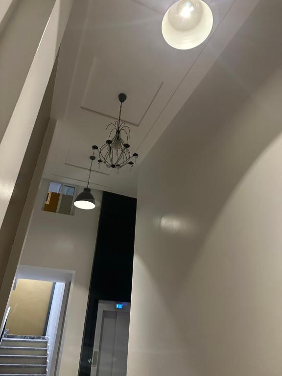 a hallway with a chandelier and a stair case at appartement à oujda in Oujda