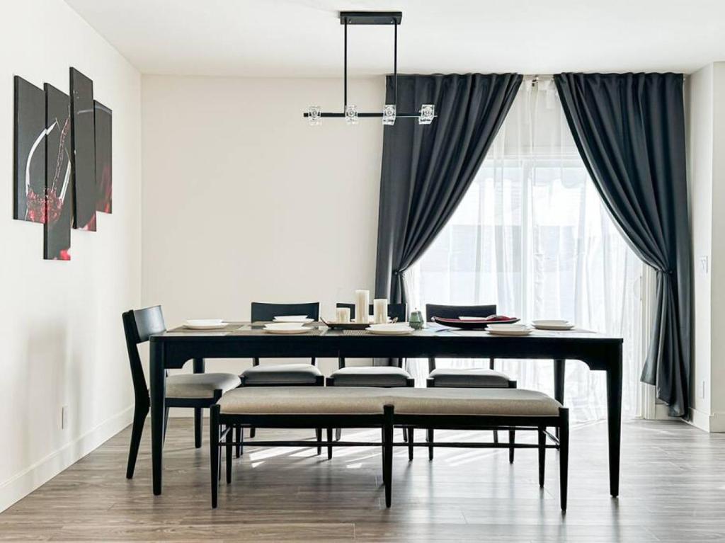 a dining room with a black table and chairs at Modern Friendly 3BR Habitat - WO - BUR in Burbank