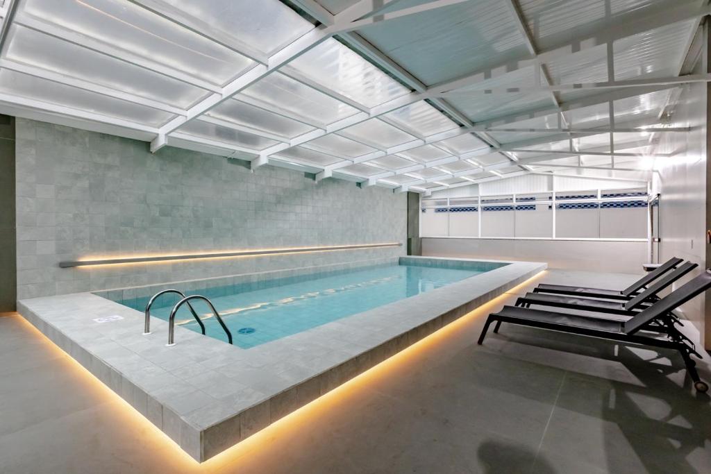 a large swimming pool in a room with a pool at Hotel Pires in Balneário Camboriú