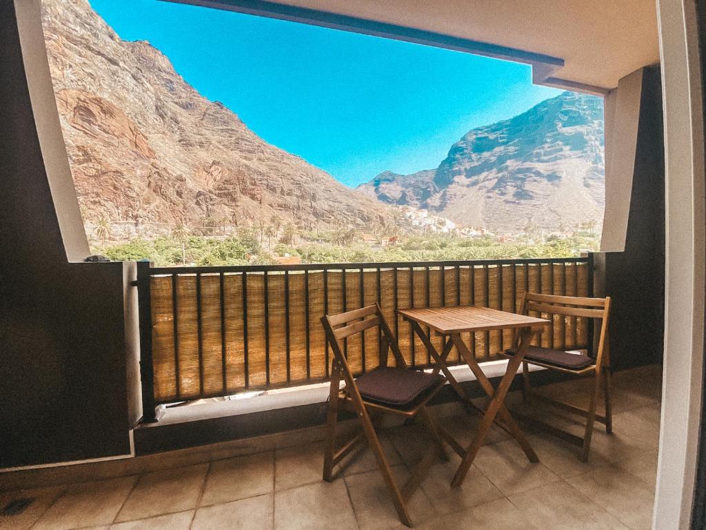 a table and chairs on a balcony with a view at Playa Maria Apartment 43 (Puerta al Cielo) in La Playa Calera