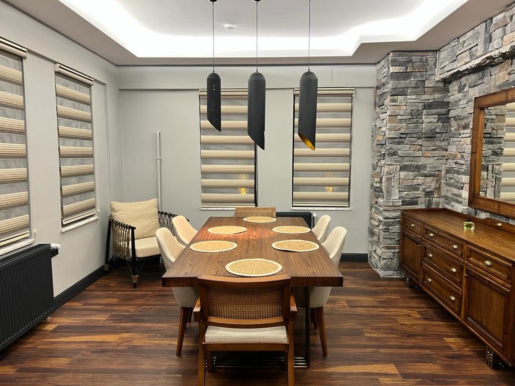 a dining room with a wooden table and chairs at Kerem ile Aslı Butik Hotel in Melikgazi