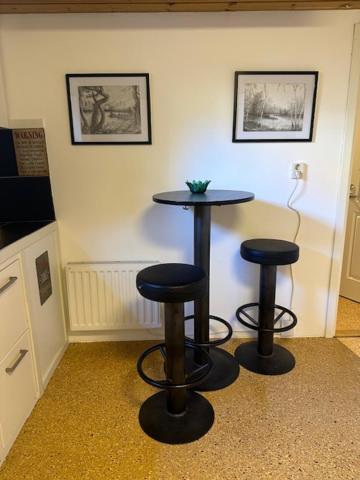 a room with two bar stools in a room at B & E Apartment in Huddinge