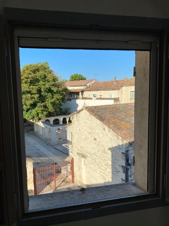 a view from a window of a building at Bienvenue au 6 - Calme et charme de la pierre. in Fourques