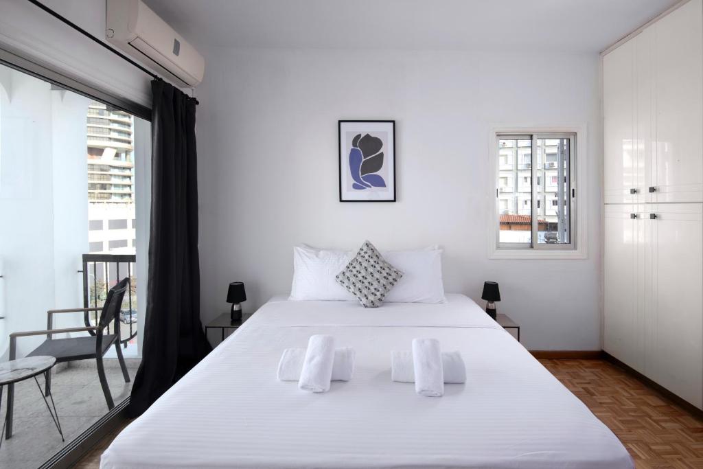 - une chambre avec un grand lit blanc et un balcon dans l'établissement Urban Condo 10 - 2 Bdr, à Nicosie