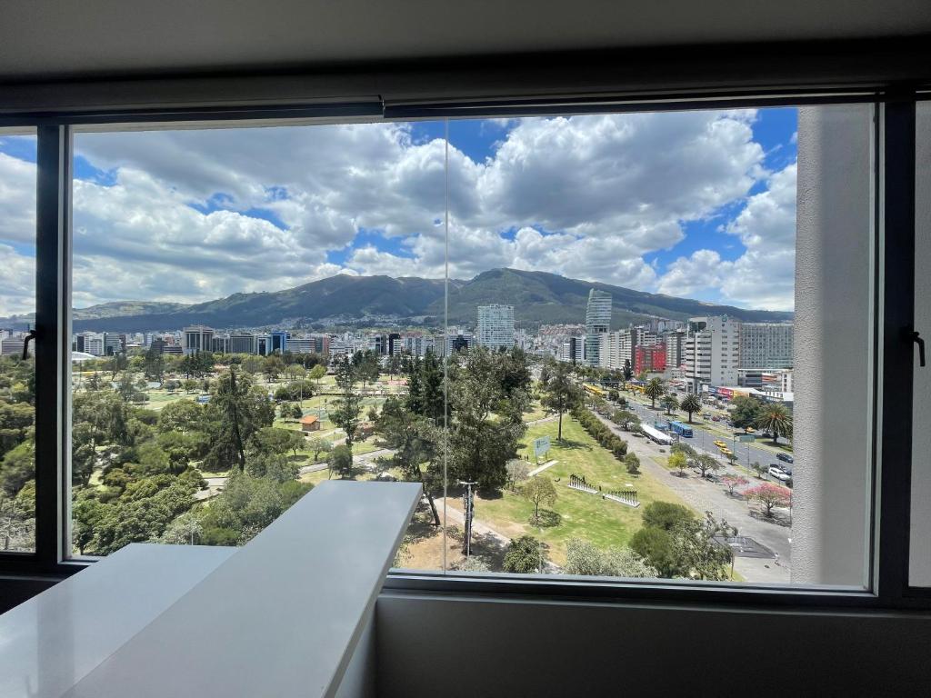 a window with a view of a city at Five Stars Suites - Park - Quito in Quito