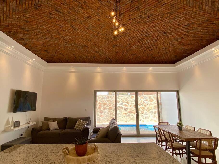 a living room with a couch and a table at CASA PITAHAYA con alberca privada Col El Mirador in San Carlos