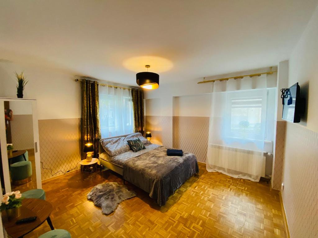 a bedroom with a bed and a large window at ClickTheFlat Solidarności City Center Apart Rooms in Warsaw
