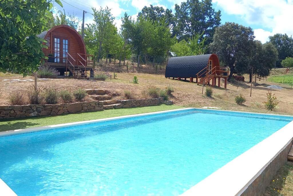una piscina frente a una casa con un granero en Quinta Da Devesa B1, en Vinhais