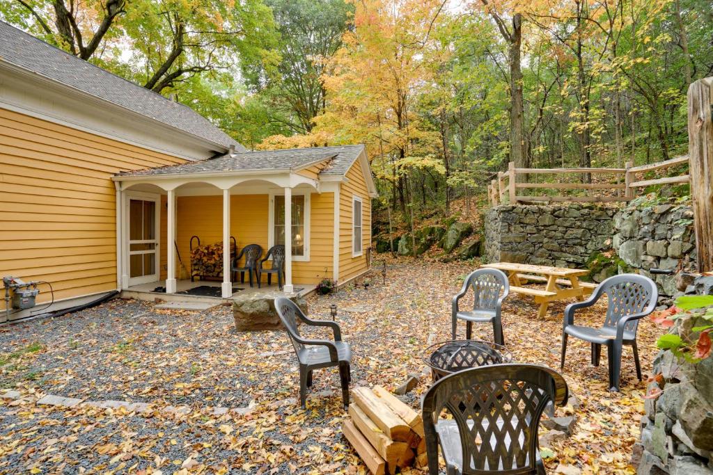 a patio with chairs and a table in front of a house at Historic Home in Taylors Falls with Patio and Fire Pit in Taylors Falls