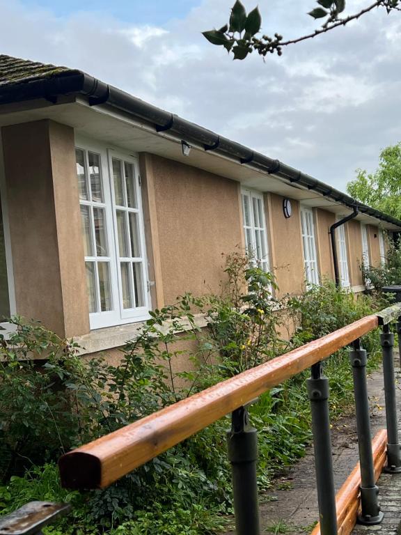 a house with a wooden railing in front of it at The annex in Bradninch