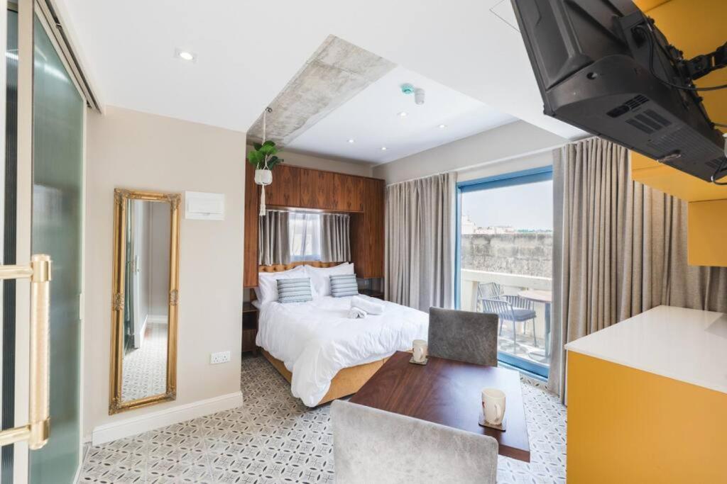 a hotel room with a bed and a large window at Iz-Zebbuga The Penthouse Royal 8 in Żebbuġ