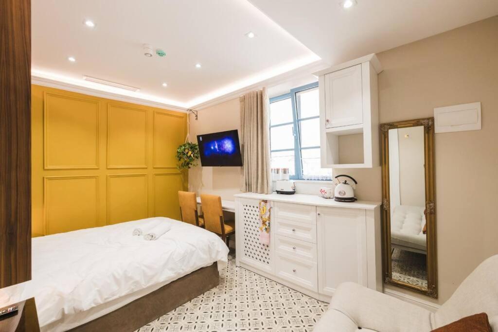 a bedroom with a bed and a sink and a mirror at Zebbuga Deluxe Lavish Suite 3 in Żebbuġ