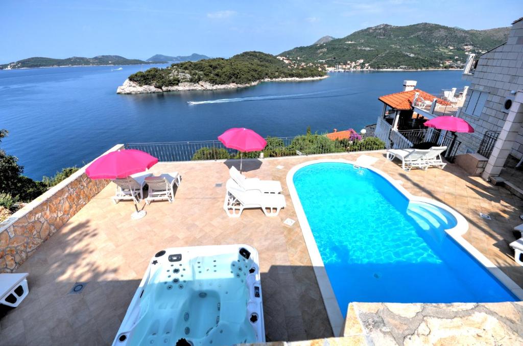 a villa with a pool and a view at Paradis Apartments in Dubrovnik