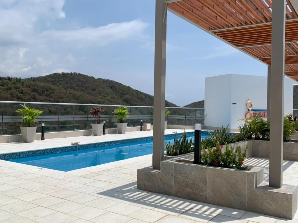 a swimming pool with a view of a mountain at APARTAMENTO EN GAIRA PLAYA SALGUERO SANTA MARTA in Gaira