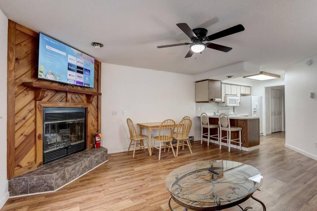 a living room with a fireplace and a table at Lighthouse Retreat II for Location and Romance in Wisconsin Dells