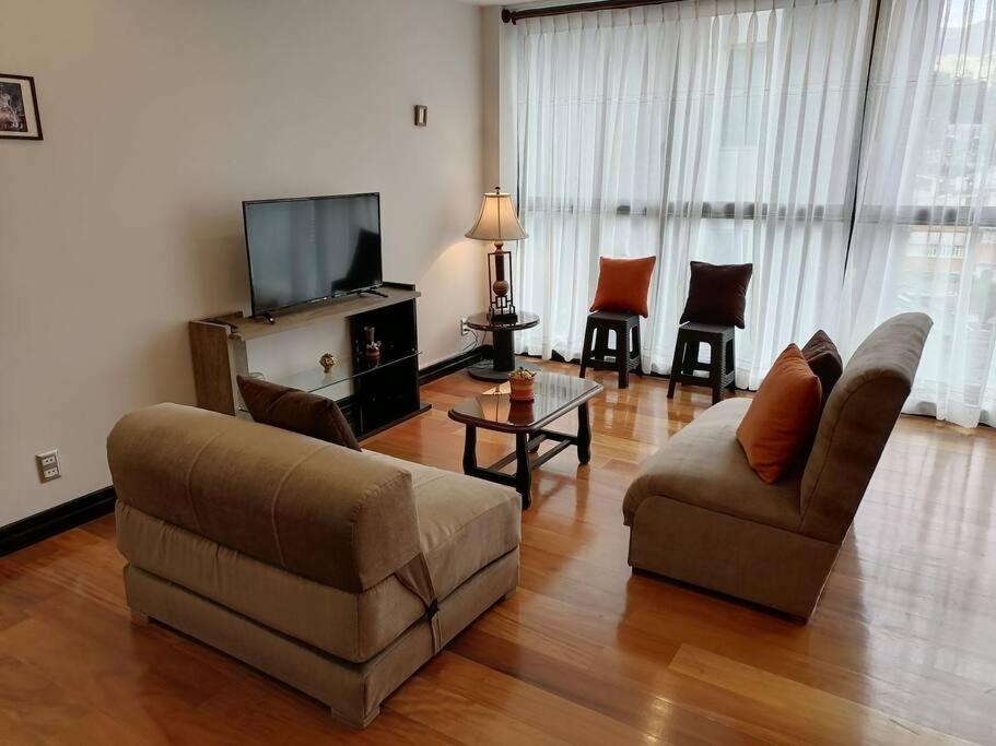uma sala de estar com um sofá e uma televisão em Hermoso dpto en piso 7, zona sur (Calacoto), 3D em La Paz