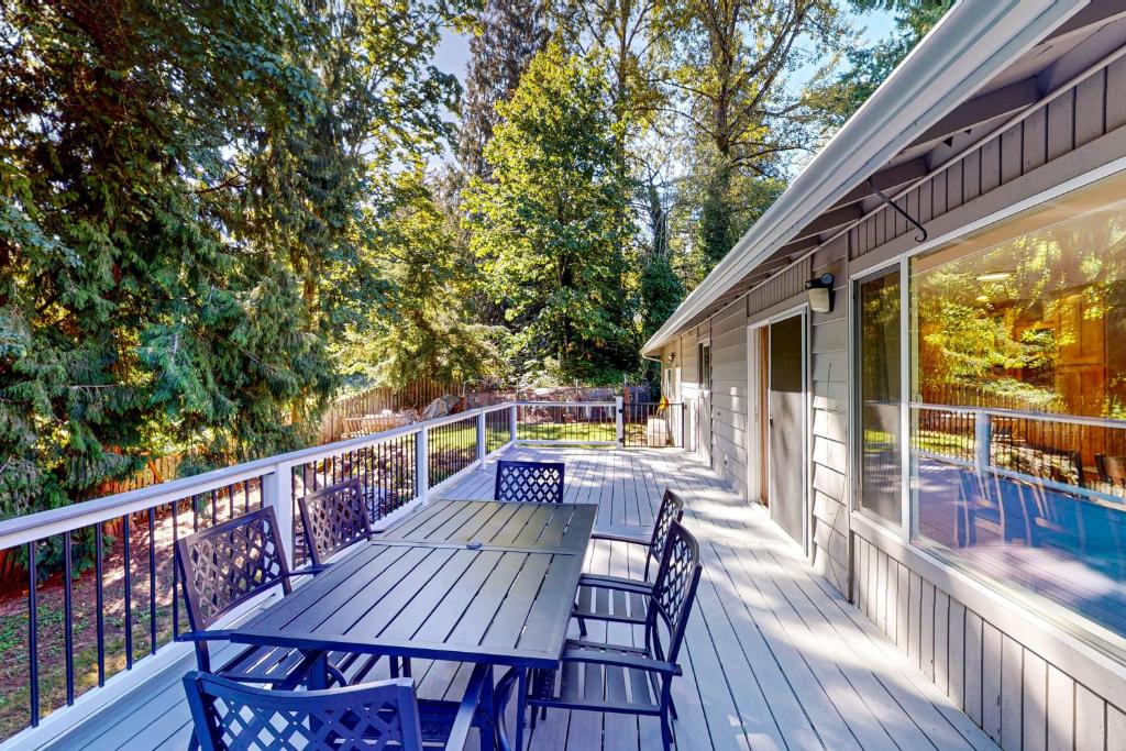 a wooden table and chairs on a porch at The Renton Rest House in Renton