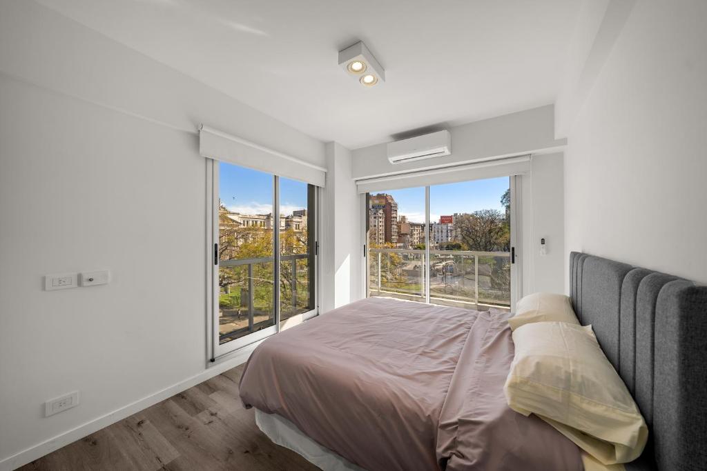 a bedroom with a bed and a large window at La Vie Suite Barrio Norte in Buenos Aires
