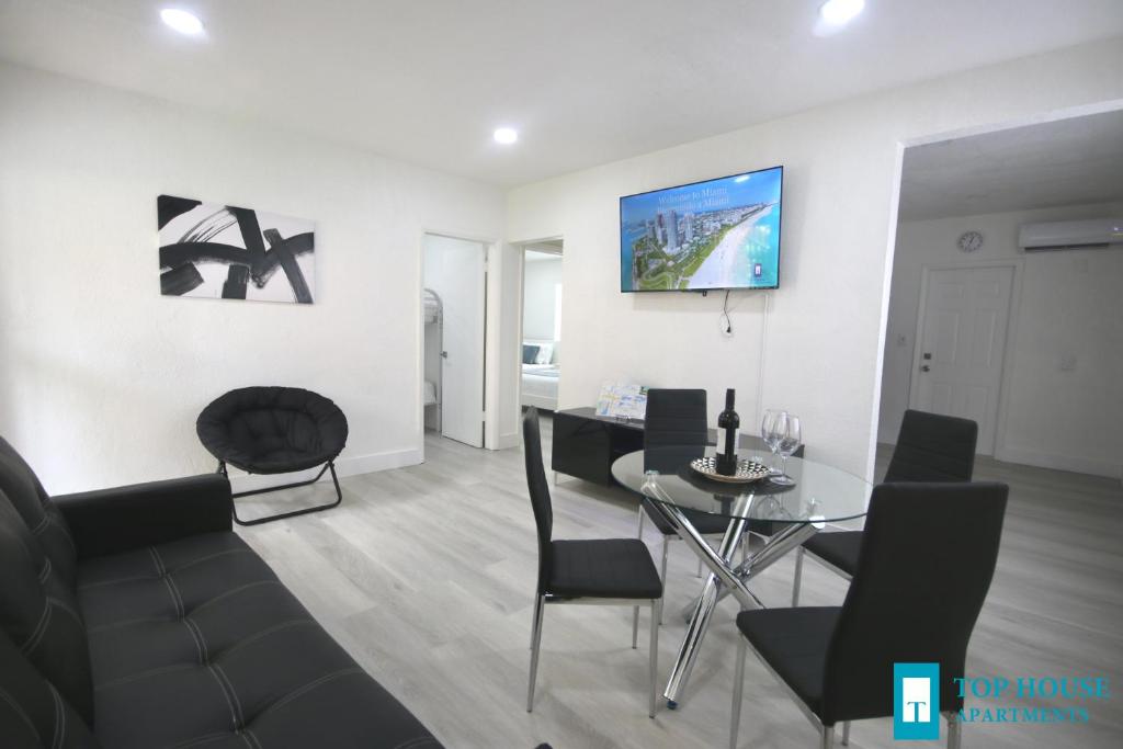 a living room with a glass table and chairs at 251 Airport/Top House Apartments in Miami